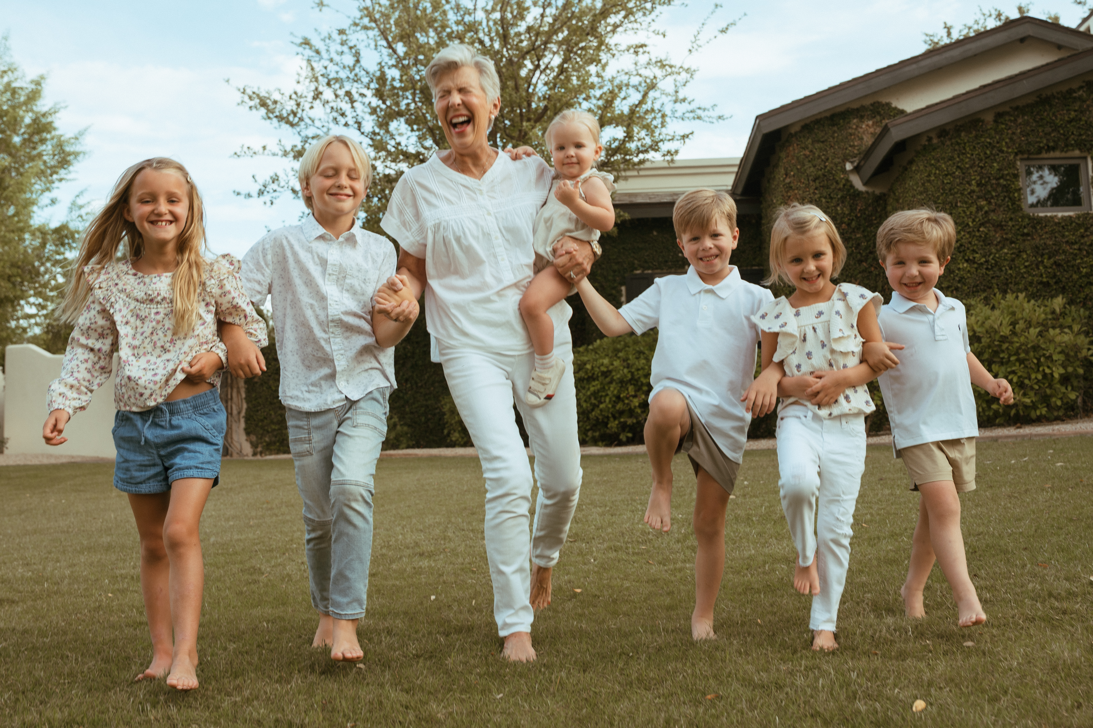 Family portrait — grandmother running with grandchildren